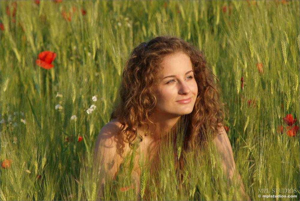 Naked teen with wavy hair models all by herself in a field of poppies - #10