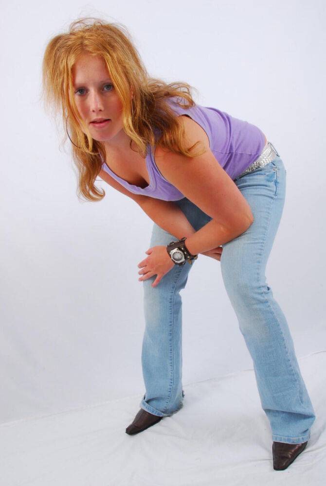 Natural redhead models a large cuff watch in a tank top and faded jeans - #9