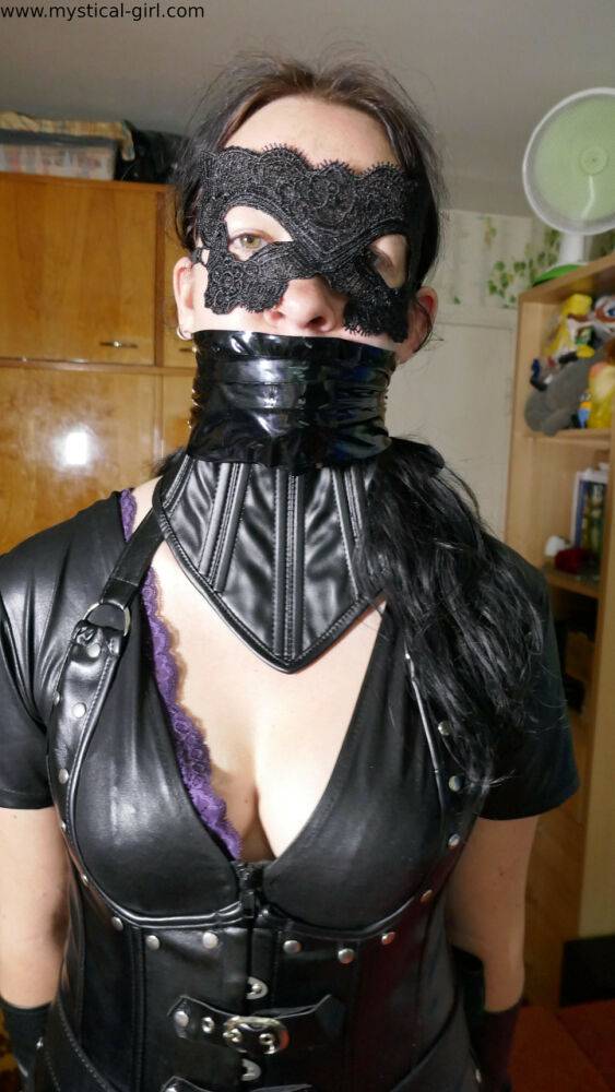 Brunette female models leather clothing while wearing a mask - #2