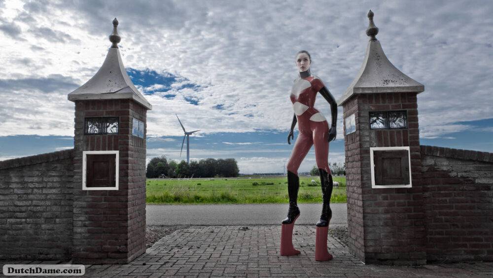 Brunette female models in red latex attire and black heels during solo action - #9