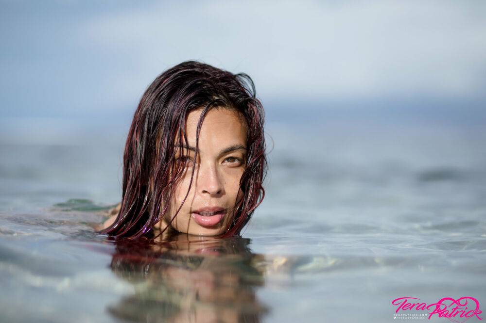 Asian chick Tera Patrick models in the ocean while wearing a gold bikini - #8
