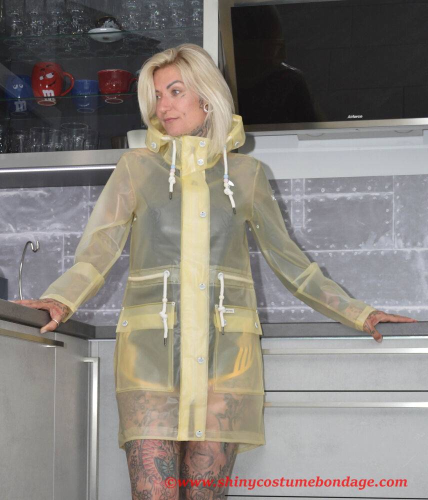 Tattooed blonde Miss Francine models barefoot in a raincoat over rubber wear - #3