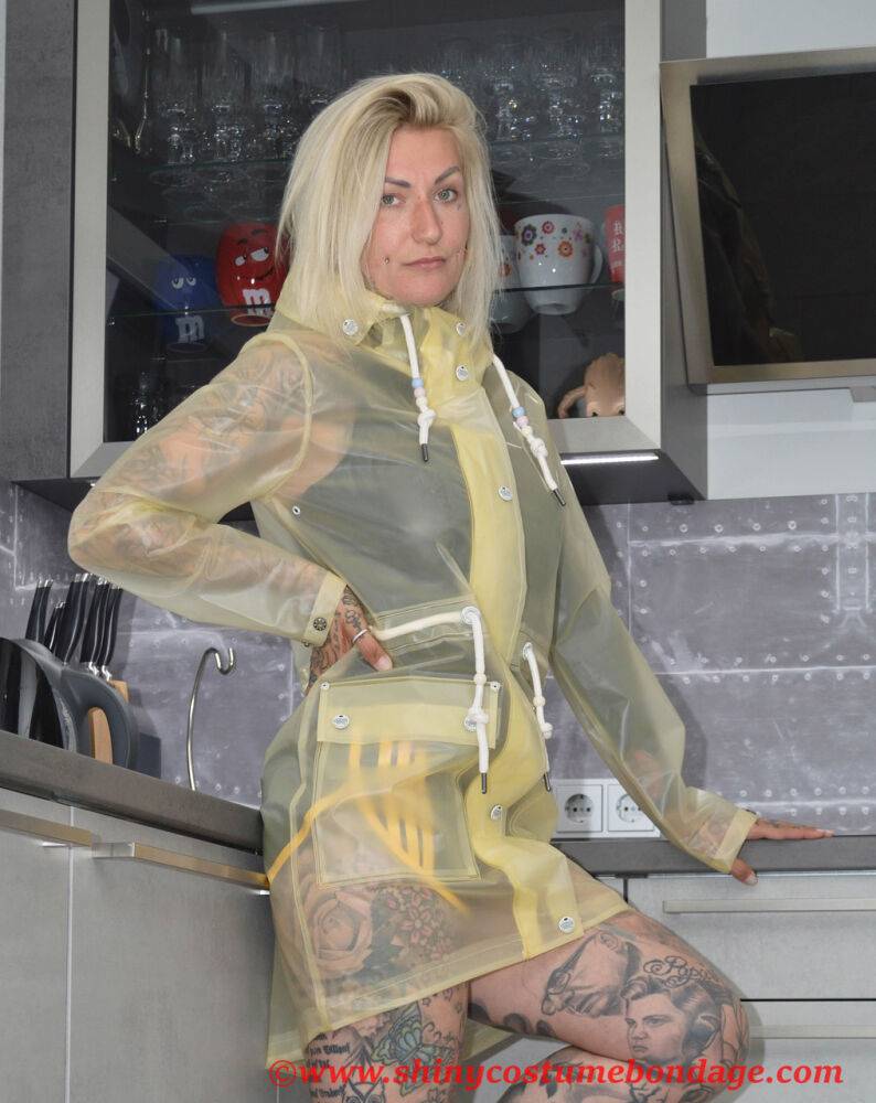 Tattooed blonde Miss Francine models barefoot in a raincoat over rubber wear - #4