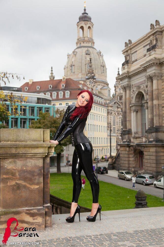 Clothed redhead Lara Larsen models latex attire and high heels in public - #9