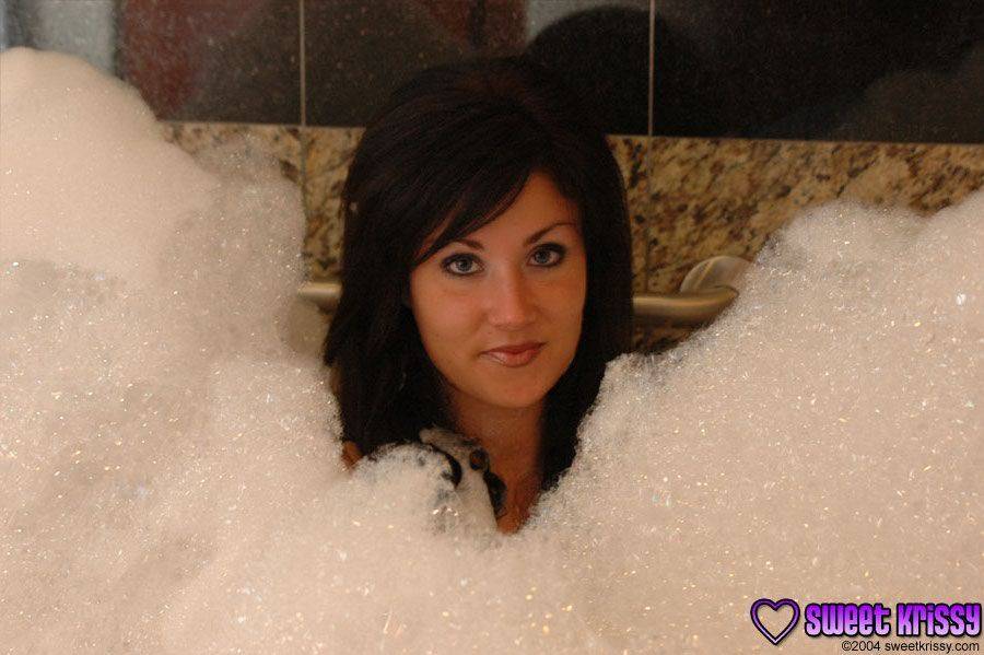 Brunette amateur Sweet Krissy models in the nude during a bubble bath - #12