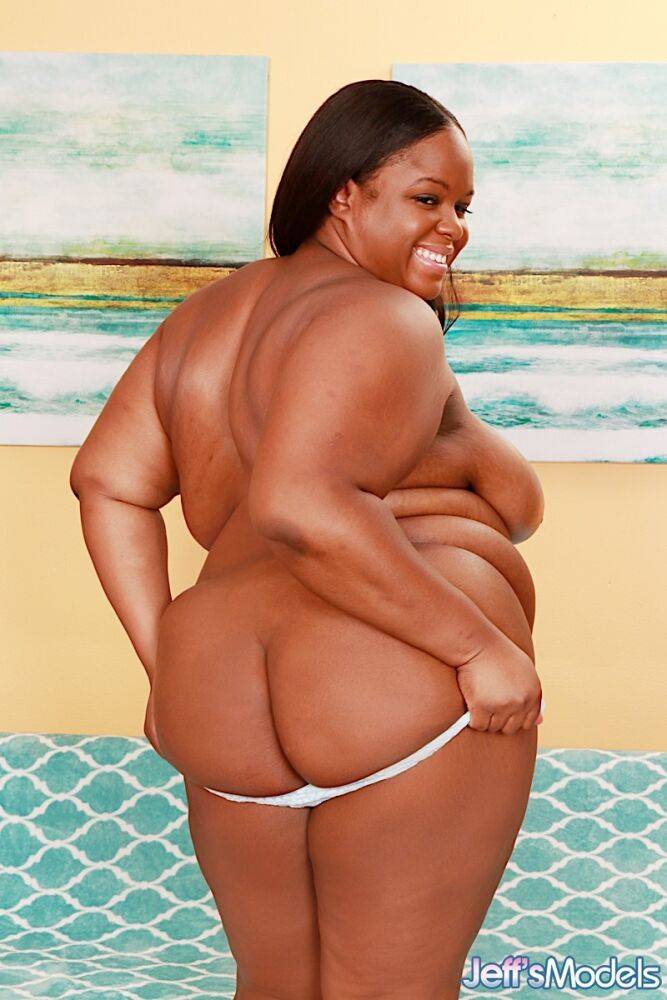 Obese black lady Olivia Leigh holds her big ass after getting naked on a futon - #14