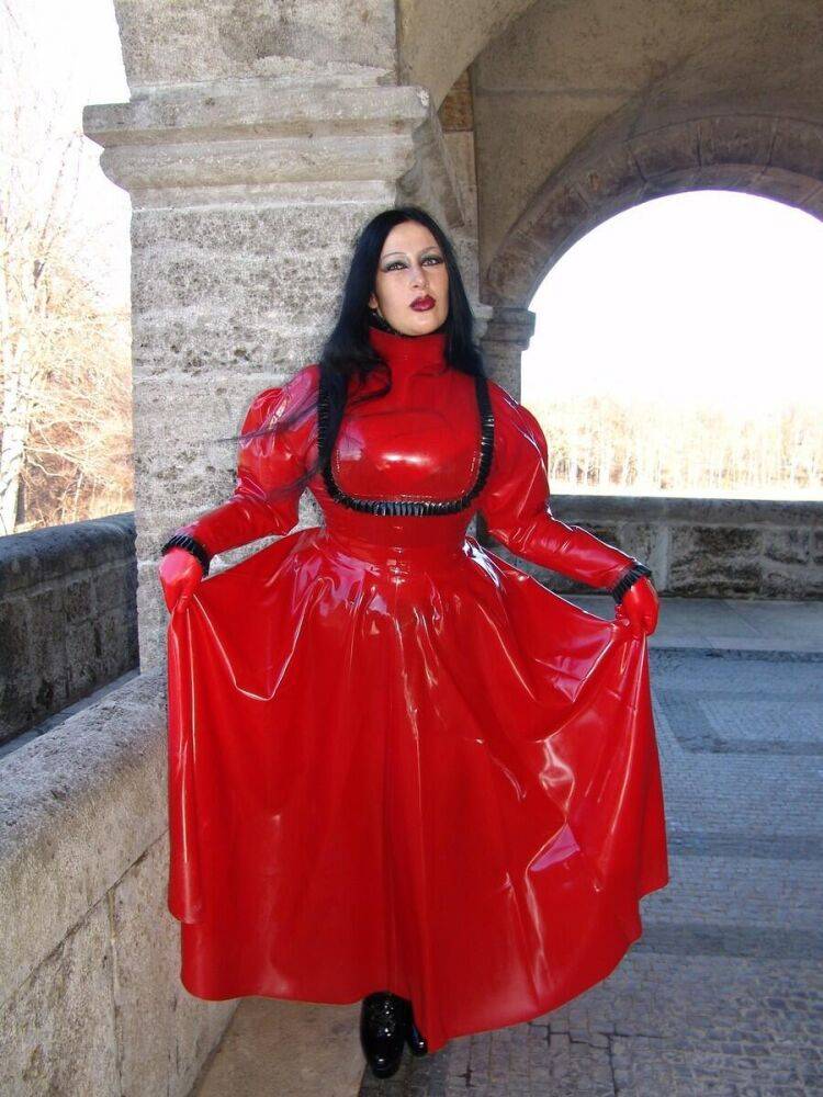 Goth woman Lady Angelina models a red latex dress during non-nude action - #6