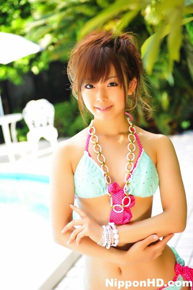 Adorable Japanese girl models a pretty bikini on a poolside patio - #8