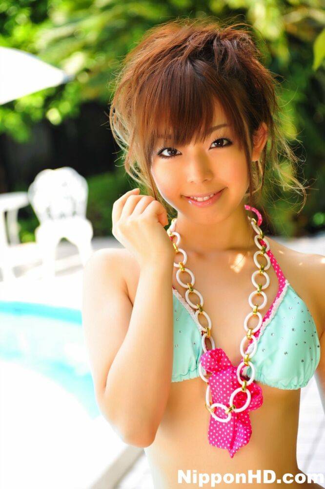 Adorable Japanese girl models a pretty bikini on a poolside patio - #3