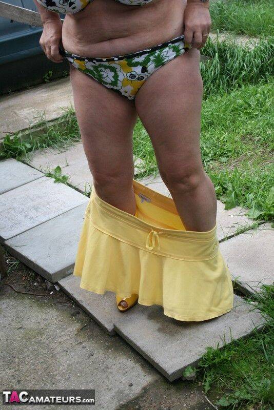 Thick older woman Kinky Carol models a bikini on patio stones - #5