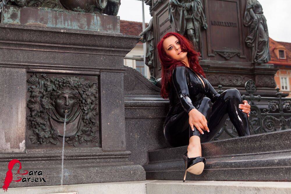 Redhead amateur Lara Larsen models on steps in latex clothing and heels - #7