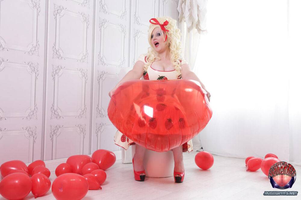 Thick blonde Avengelique models a latex dress in hosiery and red heels - #8