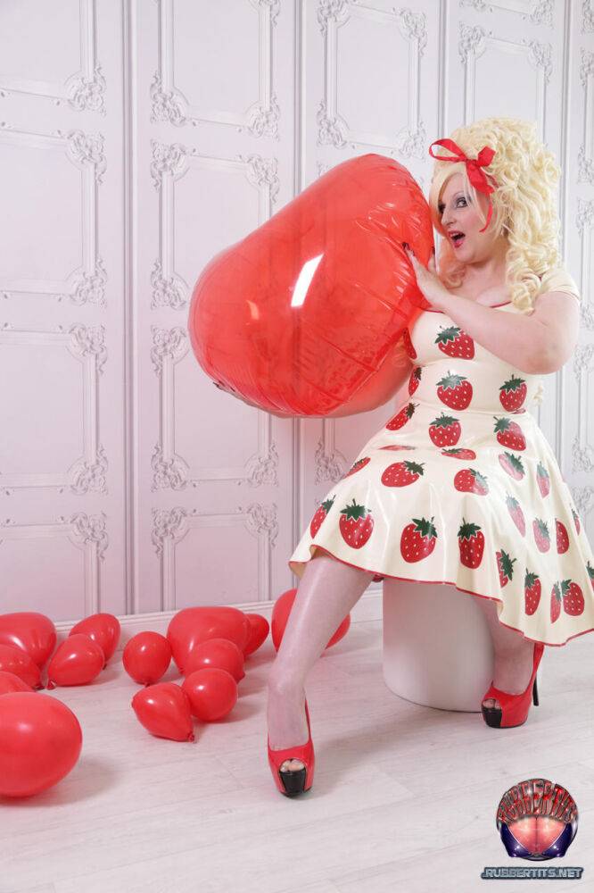 Thick blonde Avengelique models a latex dress in hosiery and red heels - #10