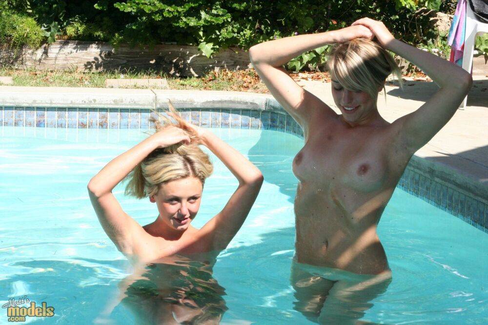 Blonde lesbians go bare naked for a dip in an outdoor swimming pool - #1