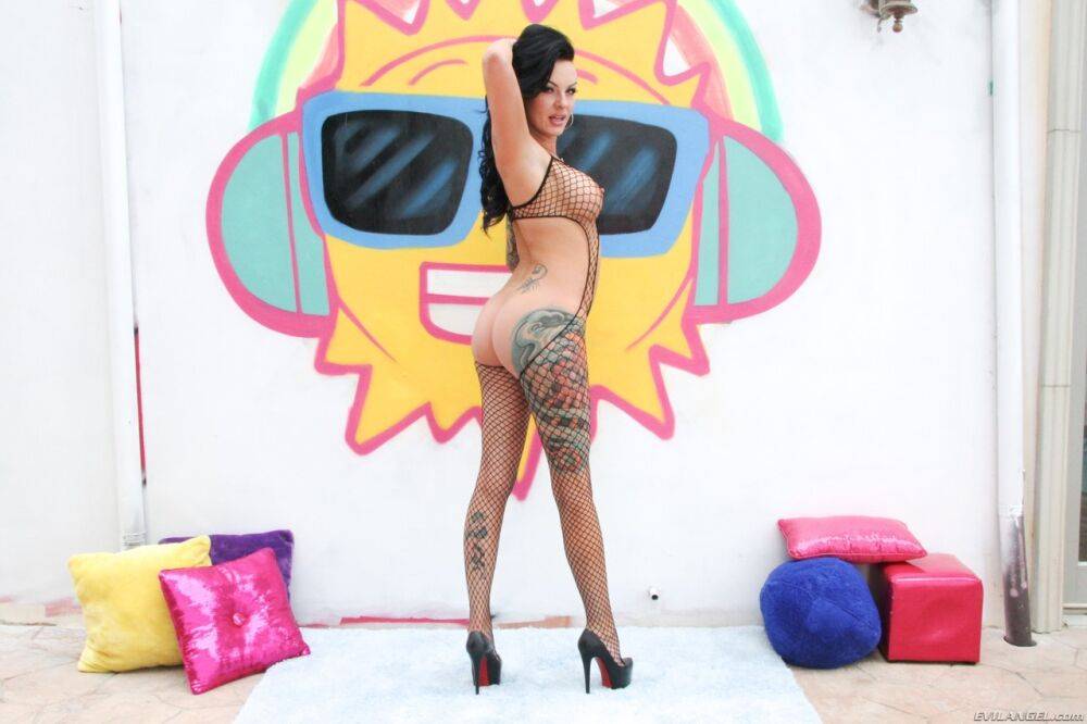 Tattooed brunette Lola Luscious models a revealing bodystocking in high heels - #12
