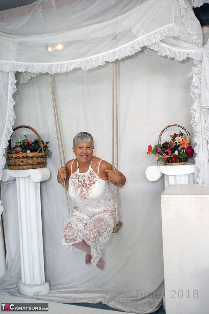 Short haired oma Savana models all white lingerie and hosiery on a swing - #13