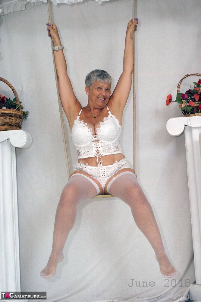 Short haired oma Savana models all white lingerie and hosiery on a swing - #2