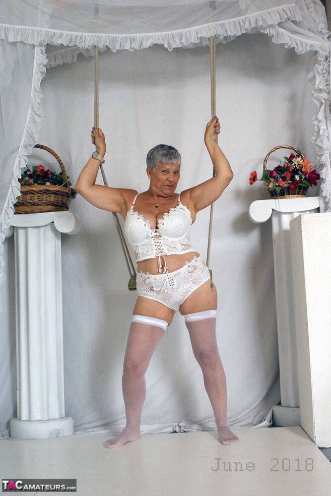 Short haired oma Savana models all white lingerie and hosiery on a swing - #15