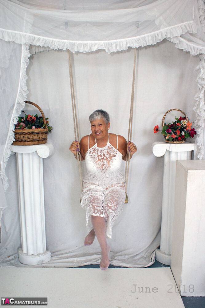 Short haired oma Savana models all white lingerie and hosiery on a swing - #6