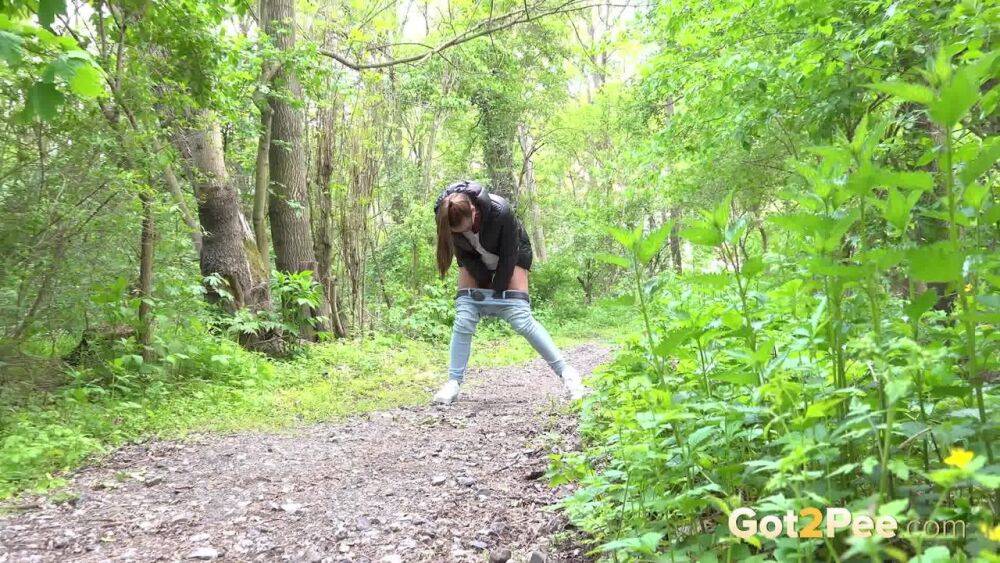 Solo girl Naomi Bennet pulls down her jeans for a piss on a path in the woods - #15