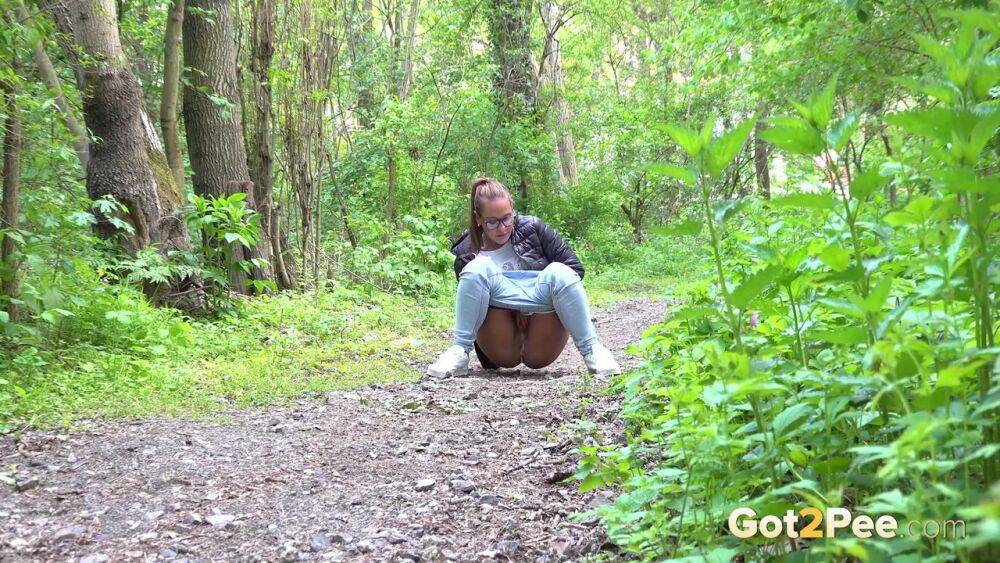 Solo girl Naomi Bennet pulls down her jeans for a piss on a path in the woods - #12