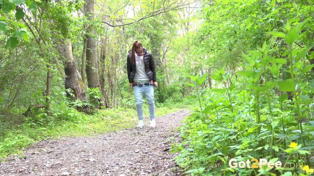 Solo girl Naomi Bennet pulls down her jeans for a piss on a path in the woods - #11