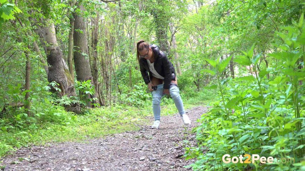 Solo girl Naomi Bennet pulls down her jeans for a piss on a path in the woods - #3