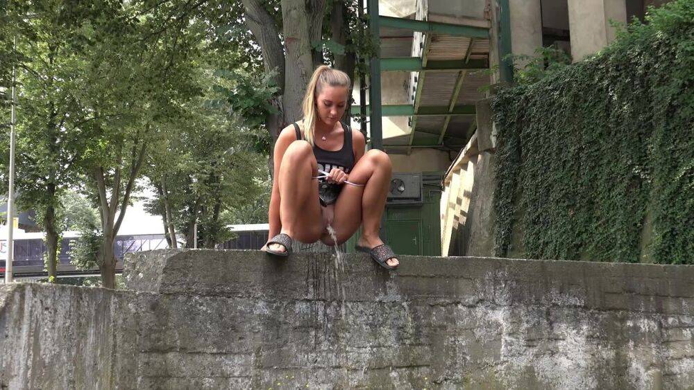 Solo girl Naomi Bennet takes a piss in public while wearing a miniskirt - #14