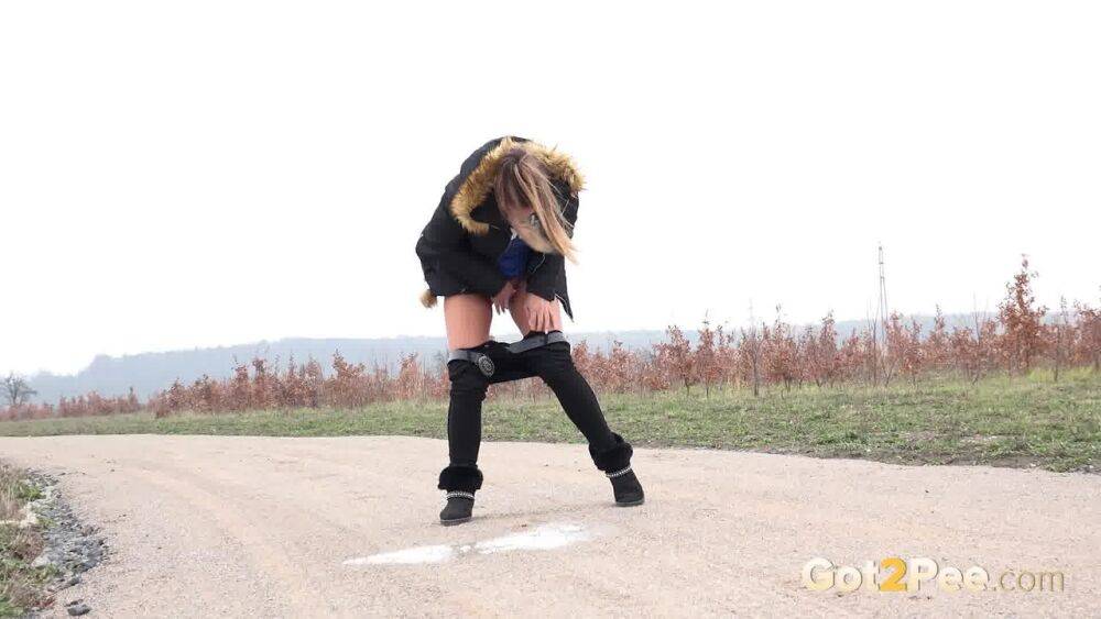 Fully clothed girl Naomi Bennet pulls down her pants to piss on a dirt road - #13