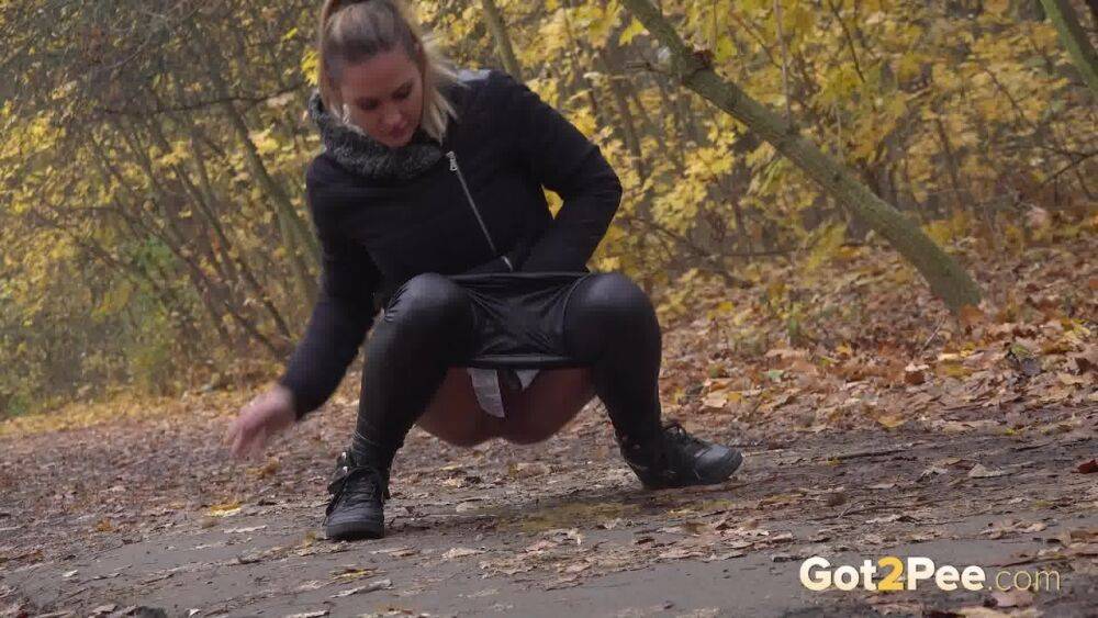 White girl Naomi Bennet takes a pee on a path while walking through a forest - #15
