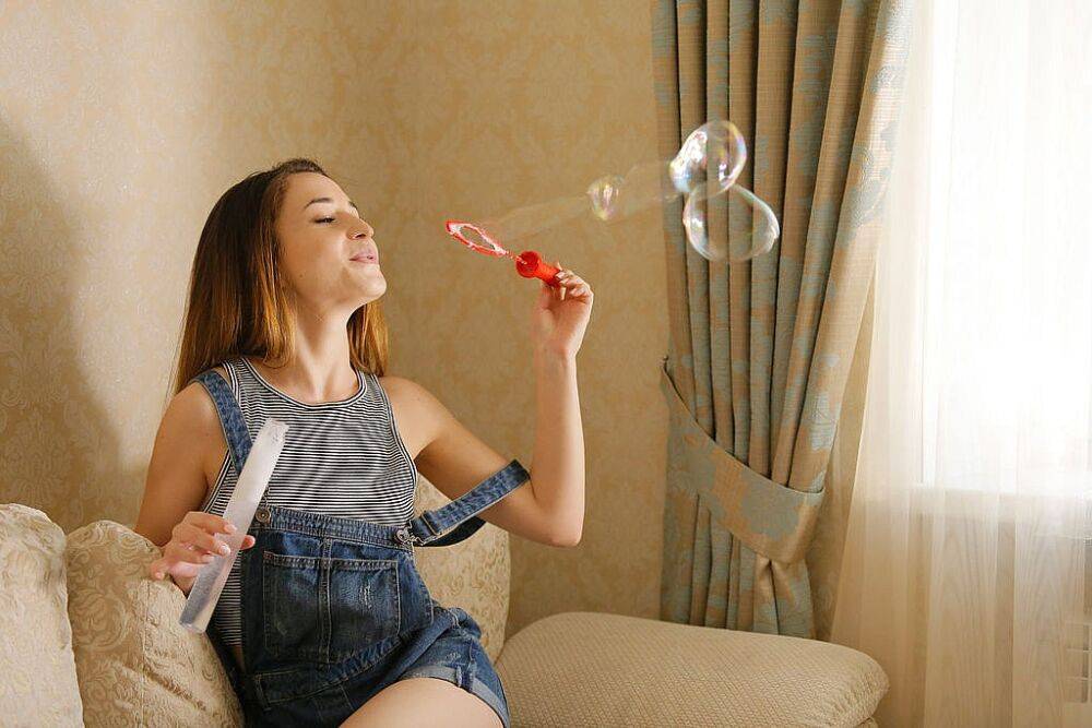 Tiny teen Susie blows bubbles before deciding to get naked on the couch - #8