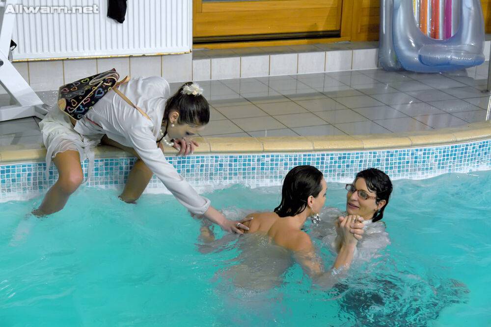 Fully clothed fetish gals spending some good time in the pool - #2