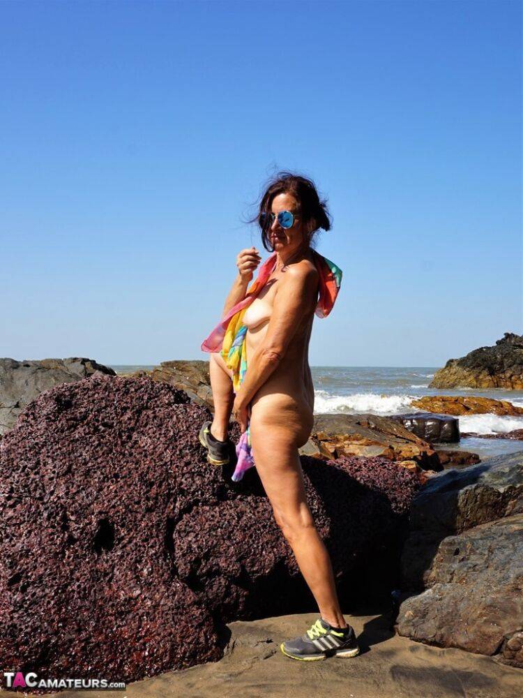 Mature amateur Diana Ananta is joined on the beach by her nudist friends - #2