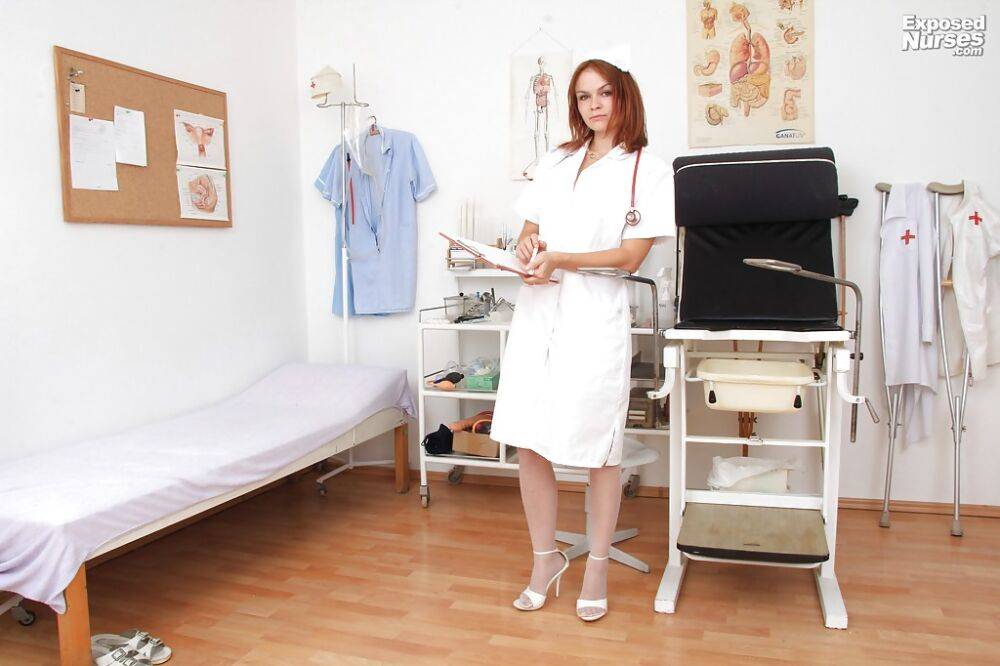 Lusty redhead nurse in nylons undressing and playing with medical tools - #3