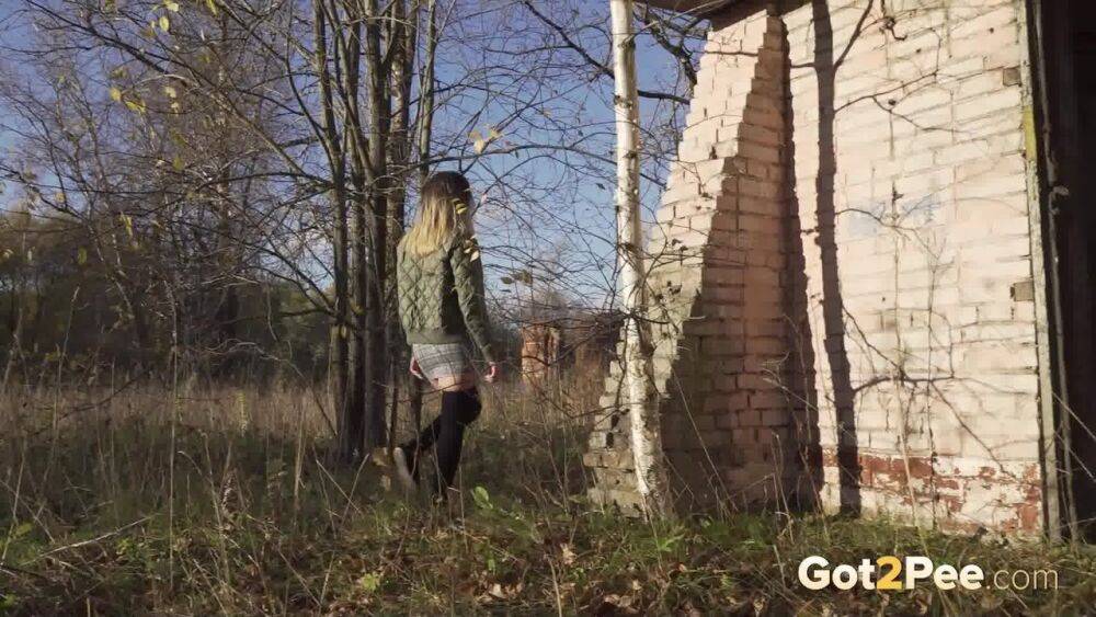 Caucasian female hikes up her skirt before pissing by a brick building - #8