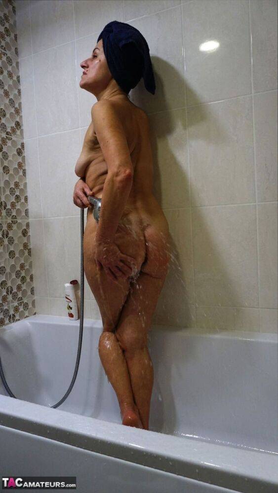 Older woman Diana Ananta displays her totally naked body while taking a shower - #1