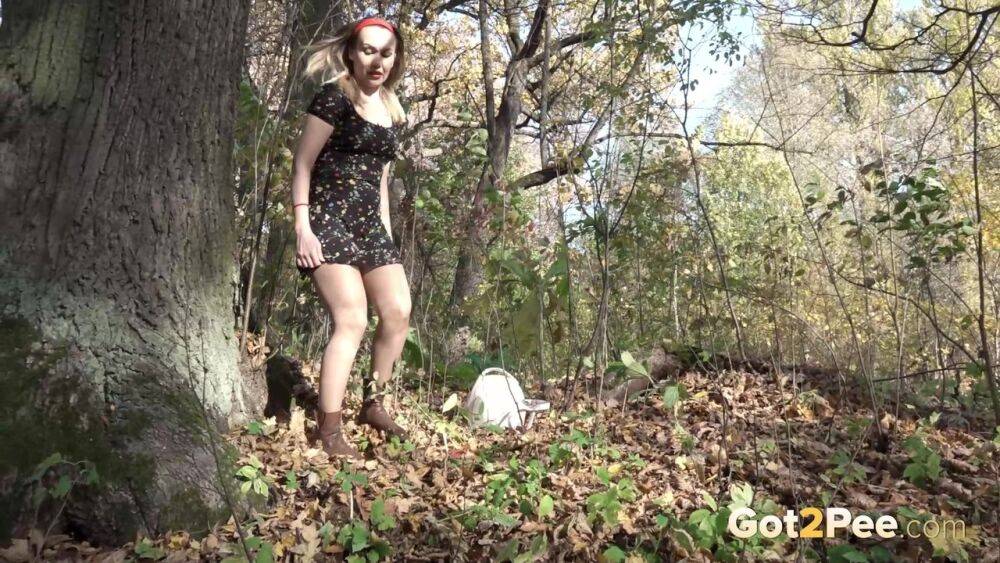 Blonde chick Diana pulls down her pantyhose to take a piss beside a tree - #10