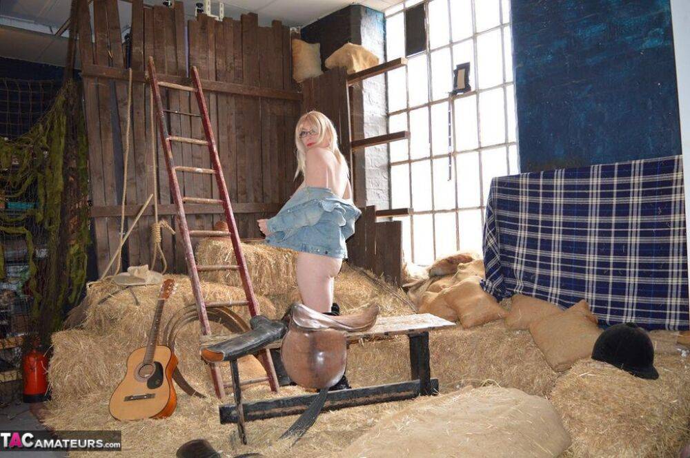 Blonde amateur Barby Slut gets naked in latex OTK boots inside a barn - #16