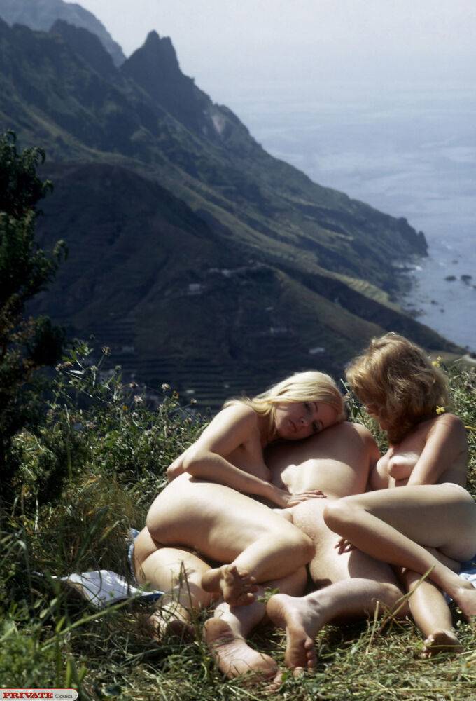 Two vintage beauties enjoy a naked outdoor threesome bang in the grass - #12