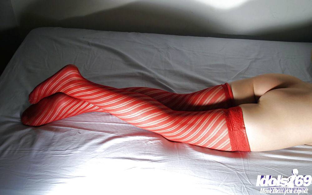 Sweet asian babe poses wearing only a hoodie and stockings - #7