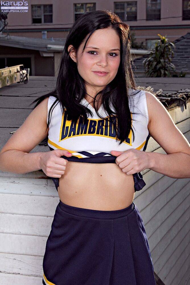 Teen cheerleader Jenna Ross doffs her uniform to pose nude on a rooftop patio - #9