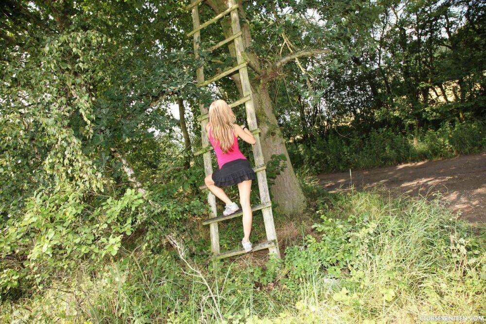 Young blonde girl Nessy strips naked on a treehouse ladder - #6