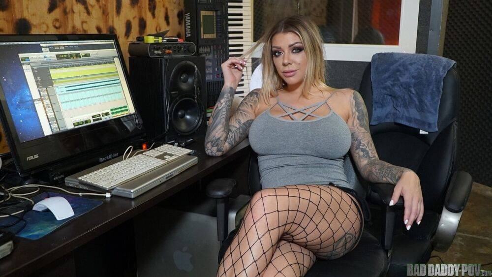 Tattooed blonde puts her enhanced boobs on display at her computer desk - #9