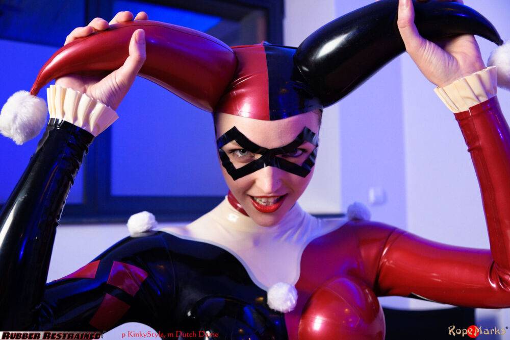 Solo model Harley Quinn poses for a non nude shoot in a costume made of latex - #16