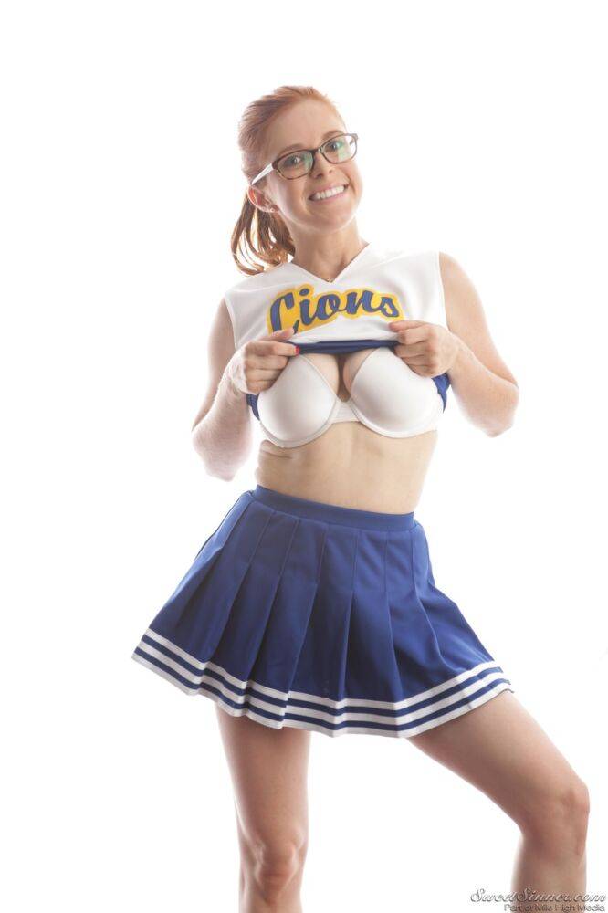 Cute redhead cheerleader Penny Pax in glasses baring big tits & firm ass - #13