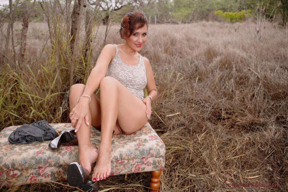 Mature pinup model Roni Ford kicks off pumps wearing retro lingerie in woods - #12