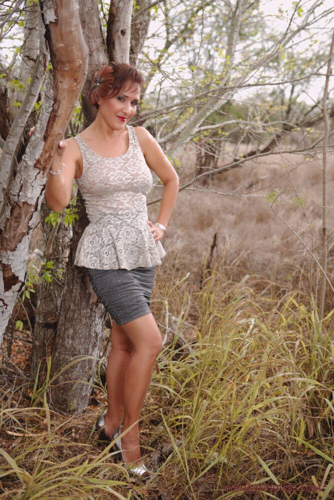 Mature pinup model Roni Ford kicks off pumps wearing retro lingerie in woods - #10