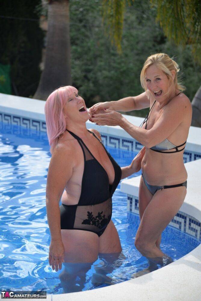 Mature BBW Melody and her girlfriend walk hand in hand by a pool in swimwear - #13