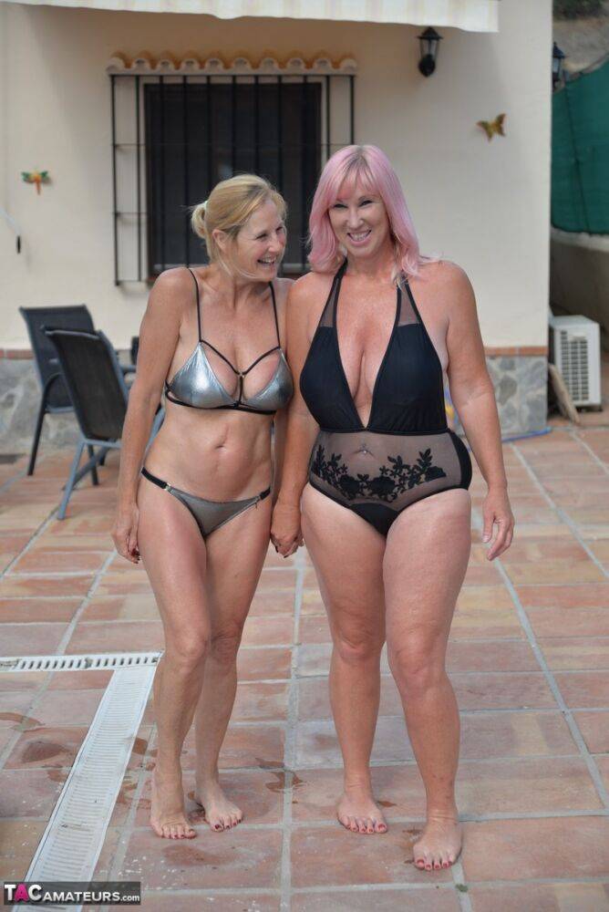 Mature BBW Melody and her girlfriend walk hand in hand by a pool in swimwear - #8