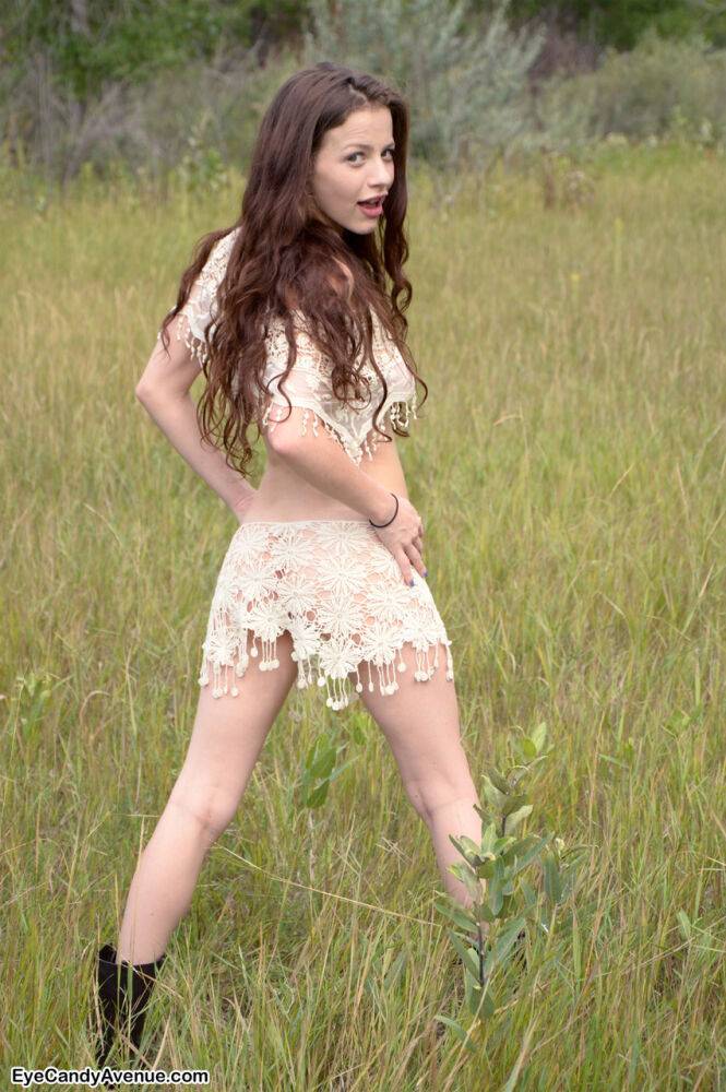 Skinny young girl Iva Nora teases her long hair in a field - #5